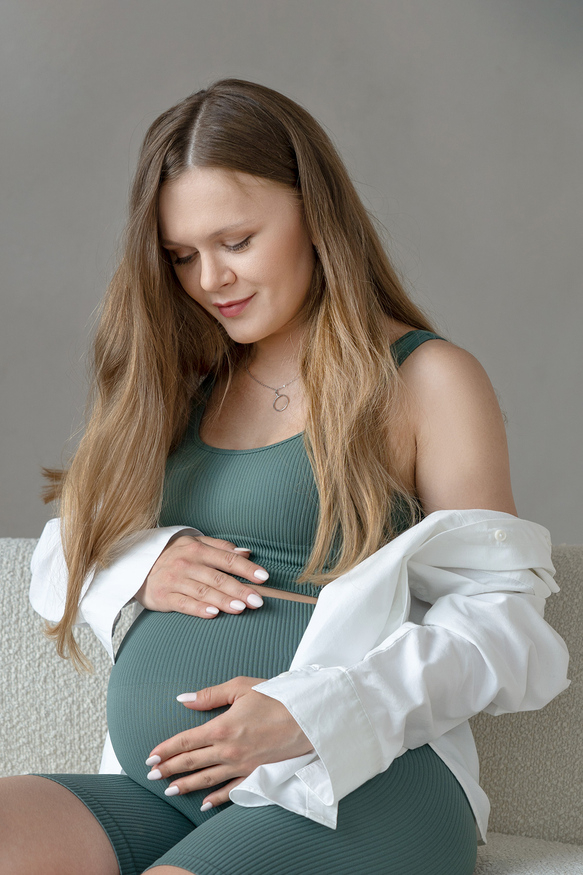 close-portrait-one-pretty-young-pregnant-woman-holding-her-belly-with-hans-looking-it